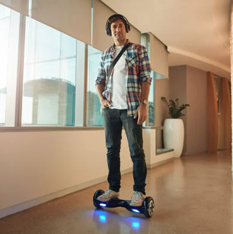 Man standing on hoverboard indoors